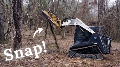 moving trees with a skid steer|skid steer for fence removal.